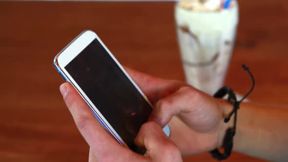 Close-up of mans hand using mobile phone