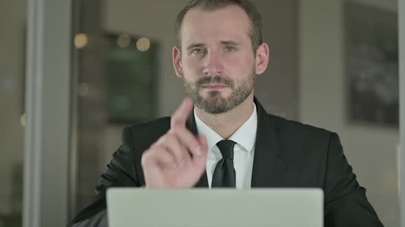 Close Up of Mature Businessman Pointing Finger to Camera at Night