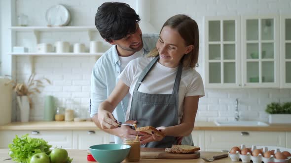 Closeup Happy Couple Cooking Together at Home. Beautiful Man and Woman Having Fun. A Young Couple