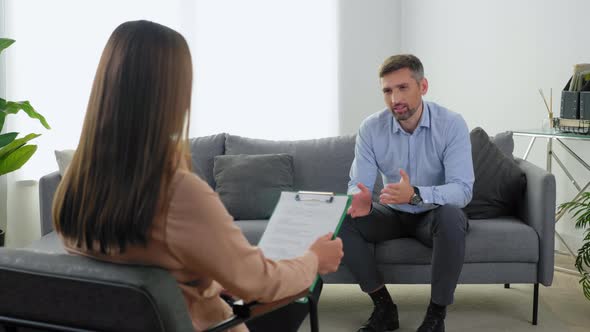 Emotional Smiling Man Patient with Mental Health Problem Talking to Therapist