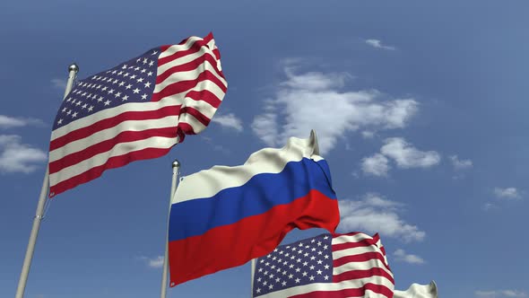 Row of Waving Flags of Russia and the USA alt