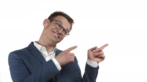 Closeup of Cheerful Funny Businessman with Blond Hair Wearing Glasses and Blue Suit Pointing Fingers