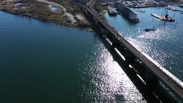 An aerial drone shot over Grassy Bay in a Queens, NY neighborhood. The camera dolly in & truck left