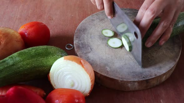 Chopping fresh zucchini for making a home cooked vegetable soup