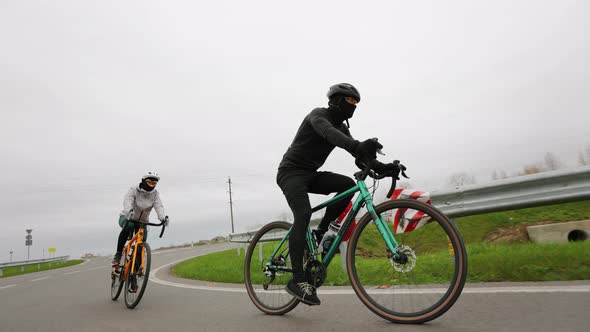 Two Athletes are Training on a Bicycle