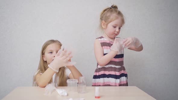 Cute Little Girls Wear Protective Gloves Before Experimenting