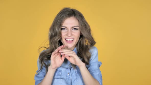 Pleased Smiling Young Girl Dancing Isolated on Yellow Background