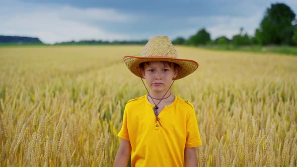 Portrait of a little farmer on field