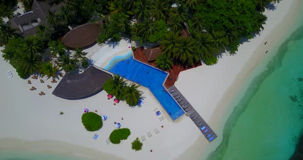 Natural fly over copy space shot of a paradise sunny white sand beach and blue ocean background in b