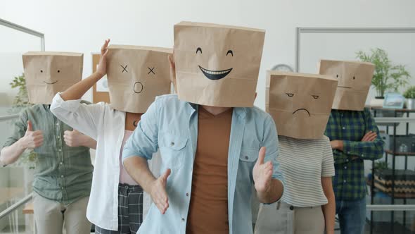 Slow Motion Portrait of Funny Office Workers Wearing Paper Bags with Emoji Pictures Expressing