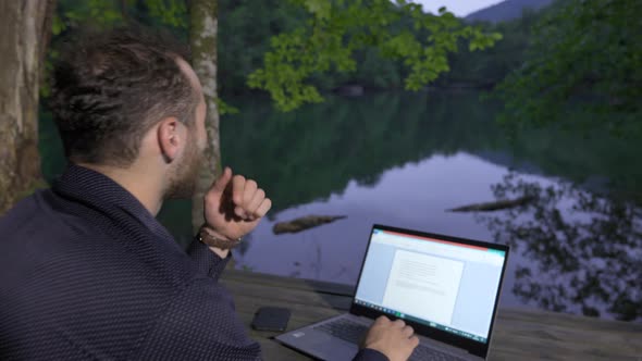 Businessman working in the forest.