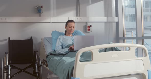 Recovering Female Patient Using Laptop While Lying in Bed