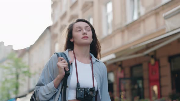 Caucasian Woman with Backpack Walking on Street