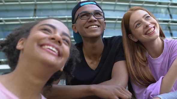 Multiethnic Females and Male Friends Enjoying Summer Music Fest, Looking Up