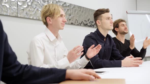 Concentrated Caucasian Businessmen Clapping After Lecture of Unknown Speaker