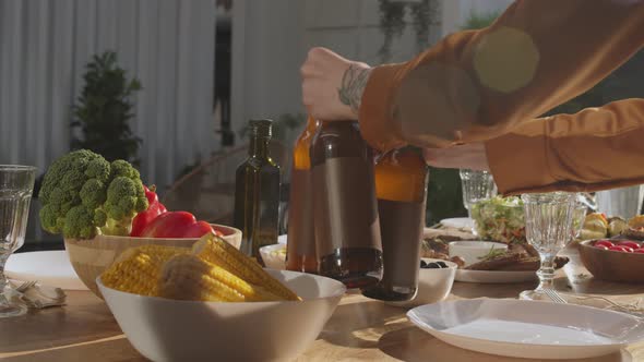 Waiter Putting Beer Bottles on the Table