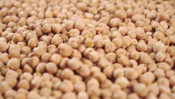 Chickpeas rotate in a heap close up.