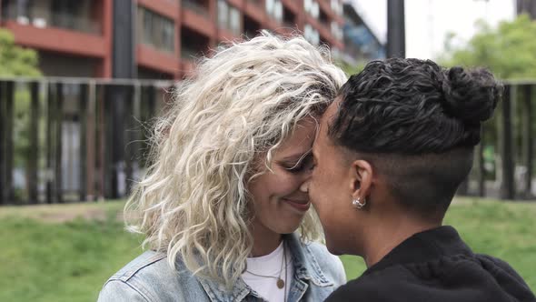 Happy mixed race lesbian couple in love kissing and cuddling - Girlfriends, m