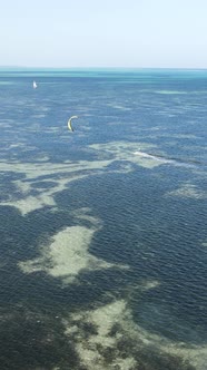 Vertical Video Kitesurfing Near the Shore of Zanzibar Tanzania