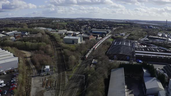Aerial footage of trains crossing each other at Stoke on Trent train station in the midlands by the