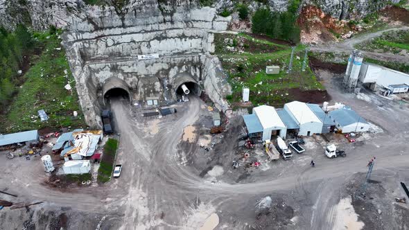 Heavy machinery drills tunnel through the mountain aerial view 4 K