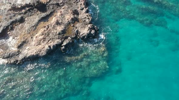 Aerial footage of reef and snorkelers at Kamaole III Beach, Maui.