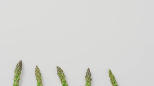 Video of fresh asparagus with copy space over white background