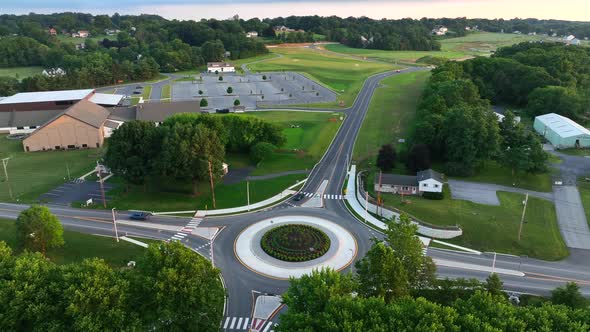 Traffic circle in suburban America. Nice landscaping and cars driving slowly around the traffic circ