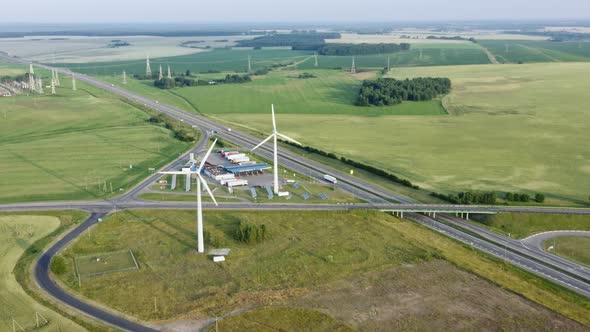 Aerial View Windmills Wind Turbines Producing Clean Ecological Electricity By Road in Green
