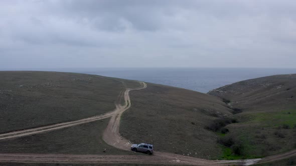 Offroad Suv Car Riding on Road Top of High Cliff Near Natural Sea