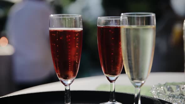 On the table is a bunch of glasses with champagne and wine. Wine tasting, some party or wedding