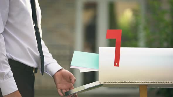 Man Receiving Letters and Bills in Mailbox in Front of House, Mail Delivery