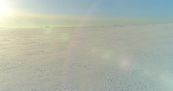 Aerial View of Cold Winter Landscape Arctic Field Trees Covered with Frost Snow Ice River and Sun