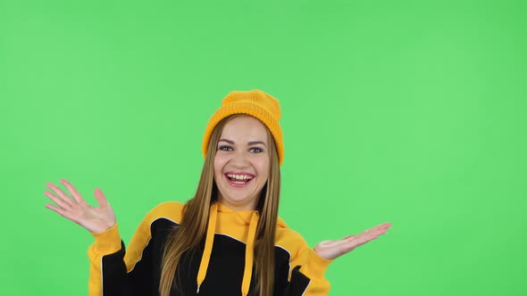 Portrait of Modern Girl in Yellow Hat Is Laughing