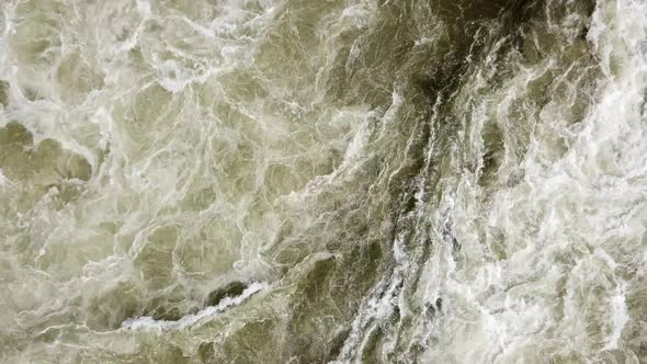 Aerial drone top view of the swirling and rushing water texture of the Nile River, Jinja, Uganda. Ra