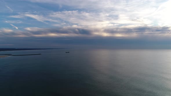 Sea At Evening With Cargo Ship On Horizon