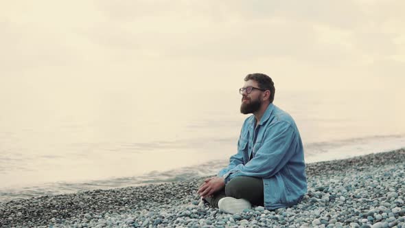 Happy Man Sitting on Beach