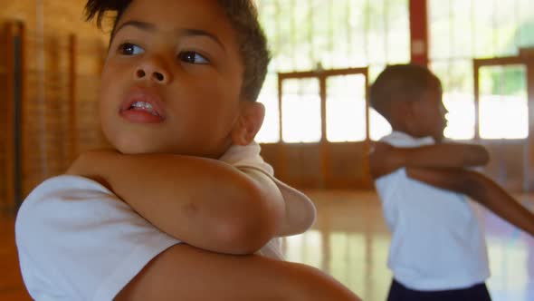 Schoolkids performing yoga in elementary school 4k