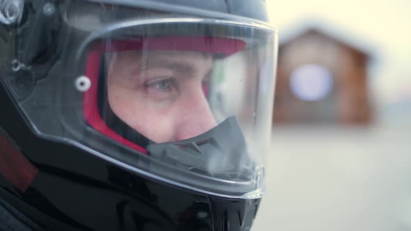 Biker looks at the world through the transparent visor of a motorcycle helmet