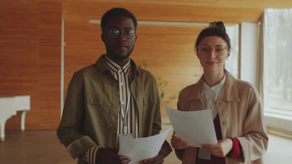 Portrait of Positive Afro Man and Caucasian Woman in Auditorium