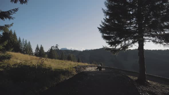 Mountain biker setting up then riding down a trail