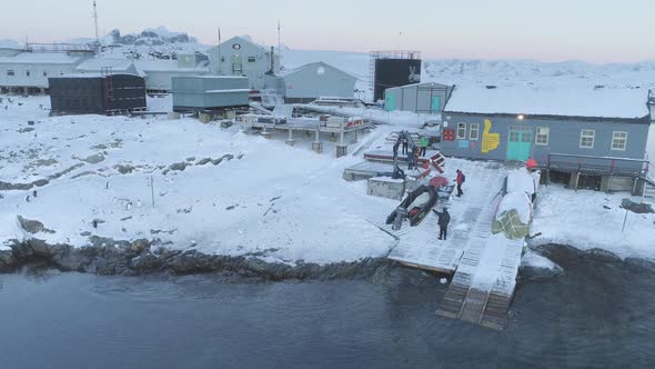People Work on Pier of Antarctic Polar Station - Vernadsky. View of Robotic Arm