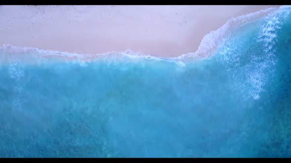 Aerial top down sky of tranquil coast beach journey by blue water and white sandy background of a da