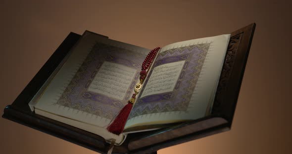 Holy Quran On Book Rest With Prayer Beads 