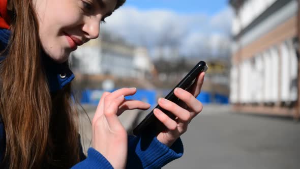 Side View of Caucasian Girl Using Smart Phone