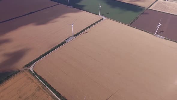 Windmills Restorative Bioenergy on the Background of Yellow and Green Fields. Aerial Survey