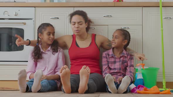 African American Family Resting After Cleanup