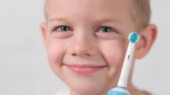 Portrait Smiling Boy with Electric Toothbrush