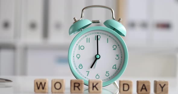 Blue Alarm Clock Standing on Desktop with Inscription Work Day Closeup  Movie