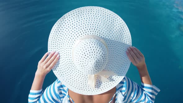 Fashion Pretty Woman Wearing White Elegance Hat and Enjoying Sunbathing at Summer Vacation